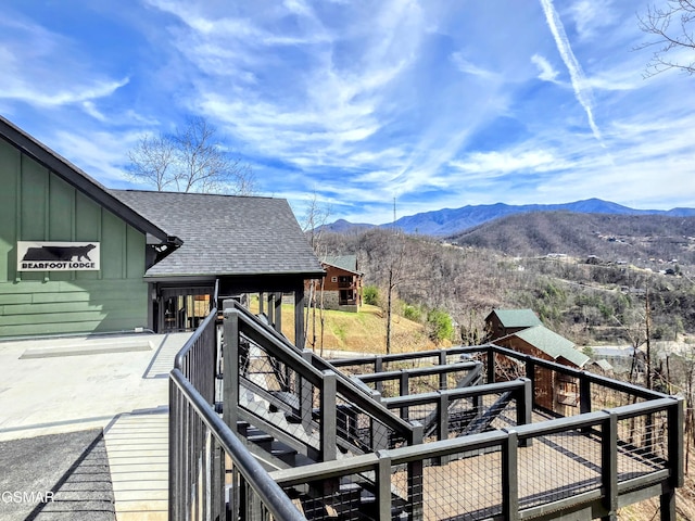 deck featuring a mountain view and stairway