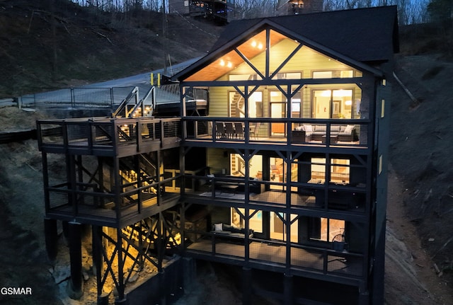 back of house with a deck