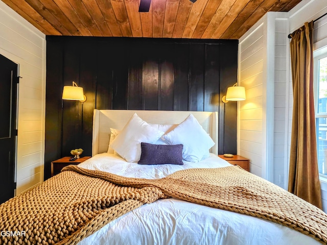 bedroom featuring wooden walls and wooden ceiling