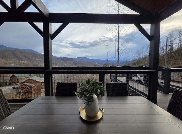 exterior space with outdoor dining area and a mountain view