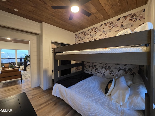 bedroom with wooden ceiling, ceiling fan, and wood finished floors
