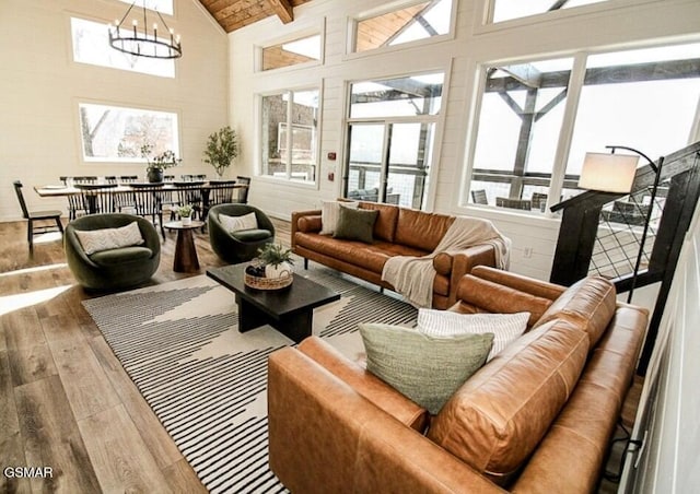 sunroom / solarium with a notable chandelier and beamed ceiling