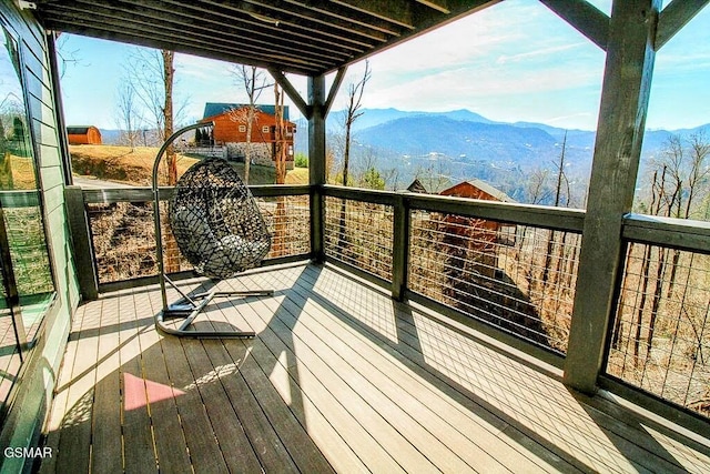 wooden deck with a mountain view