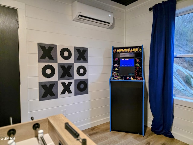 room details with an AC wall unit and wood finished floors