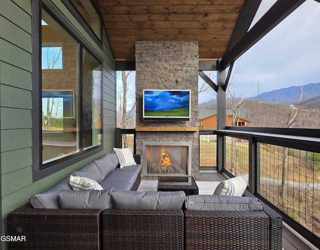 balcony with an outdoor living space with a fireplace