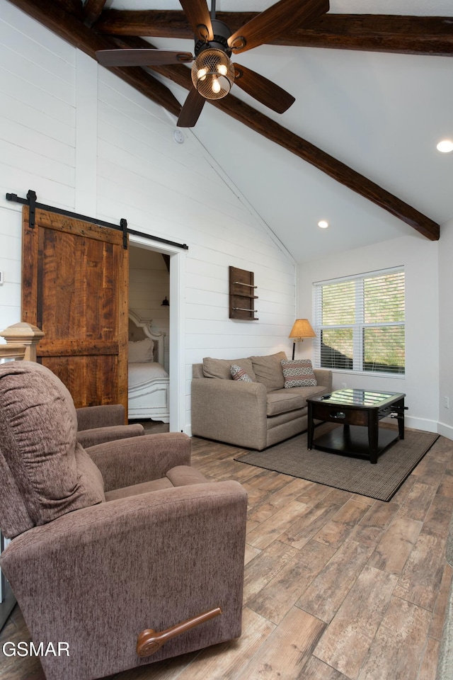 145 W Holly Ridge Rd, Gatlinburg, TN 37738 - living room featuring a barn door, a ceiling fan, beam ceiling, wood finished floors, and high vaulted ceiling
