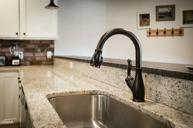 145 W Holly Ridge Rd, Gatlinburg, TN 37738 - interior details with light stone counters, a sink, and white cabinetry