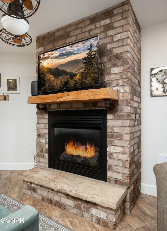 145 W Holly Ridge Rd, Gatlinburg, TN 37738 - interior details featuring wood finished floors, baseboards, and a brick fireplace