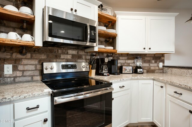 145 W Holly Ridge Rd, Gatlinburg, TN 37738 - kitchen featuring backsplash, appliances with stainless steel finishes, and open shelves