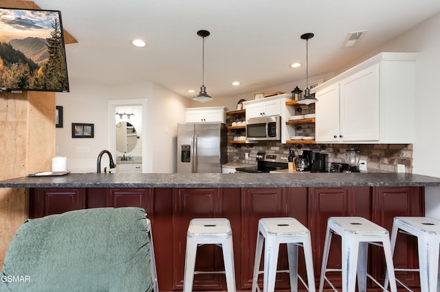 145 W Holly Ridge Rd, Gatlinburg, TN 37738 - kitchen with dark countertops, open shelves, a peninsula, and stainless steel appliances