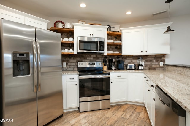 145 W Holly Ridge Rd, Gatlinburg, TN 37738 - kitchen featuring white cabinets, decorative backsplash, open shelves, and stainless steel appliances