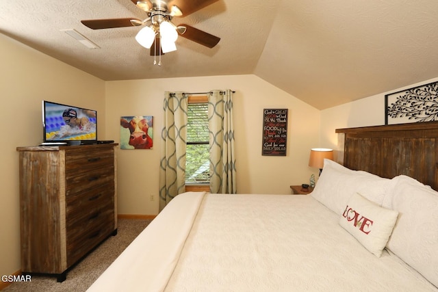 bedroom with carpet flooring, lofted ceiling, ceiling fan, and a textured ceiling