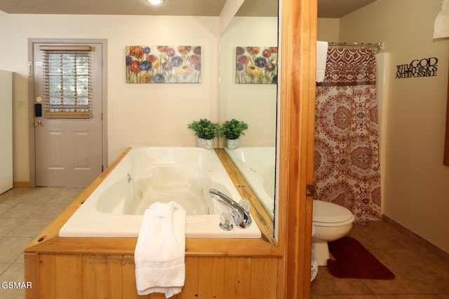 bathroom with tile patterned flooring, toilet, and a bathing tub