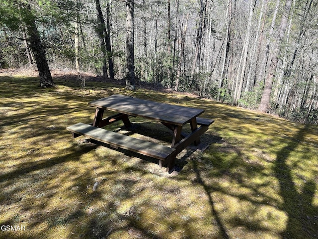 view of property's community featuring a forest view