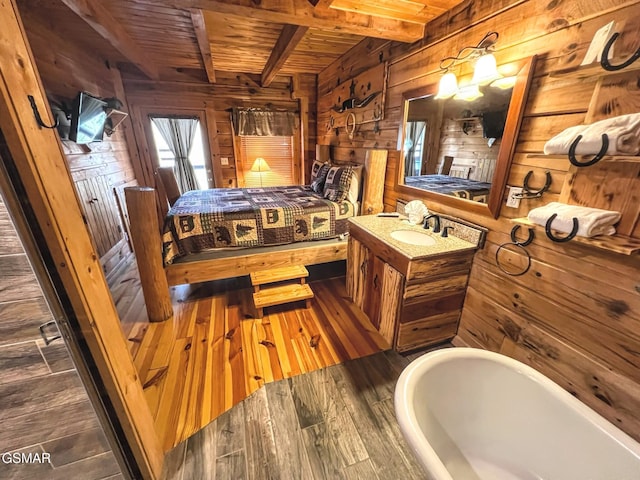 bedroom featuring beamed ceiling, a sink, wood-type flooring, wood walls, and wooden ceiling