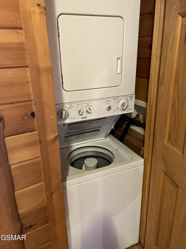 laundry area with laundry area and stacked washer / dryer