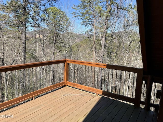 wooden deck featuring a wooded view