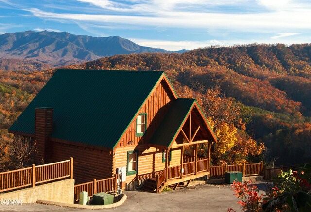 4610 High Vista Way, Pigeon Forge, TN 37863 - view of front of property with board and batten siding, a mountain view, log exterior, a metal roof, and a chimney