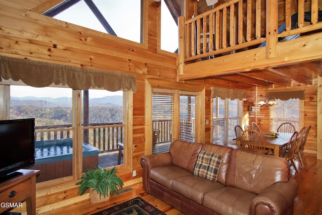 4610 High Vista Way, Pigeon Forge, TN 37863 - living room featuring hardwood / wood-style flooring, wood walls, a mountain view, plenty of natural light, and high vaulted ceiling