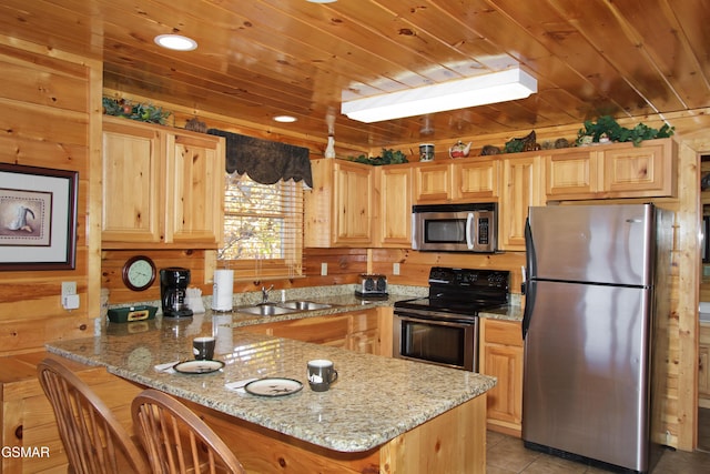 4610 High Vista Way, Pigeon Forge, TN 37863 - kitchen featuring appliances with stainless steel finishes, a peninsula, wooden ceiling, light brown cabinets, and light stone counters