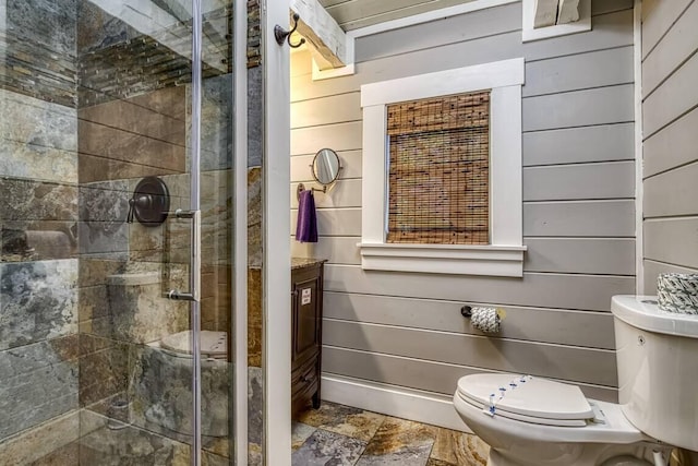 full bathroom featuring wood walls, stone finish flooring, a stall shower, and toilet
