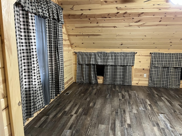 interior space with wood walls, dark hardwood / wood-style flooring, lofted ceiling, and wood ceiling