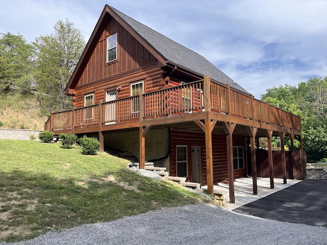 exterior space with a patio area, a front lawn, and a deck