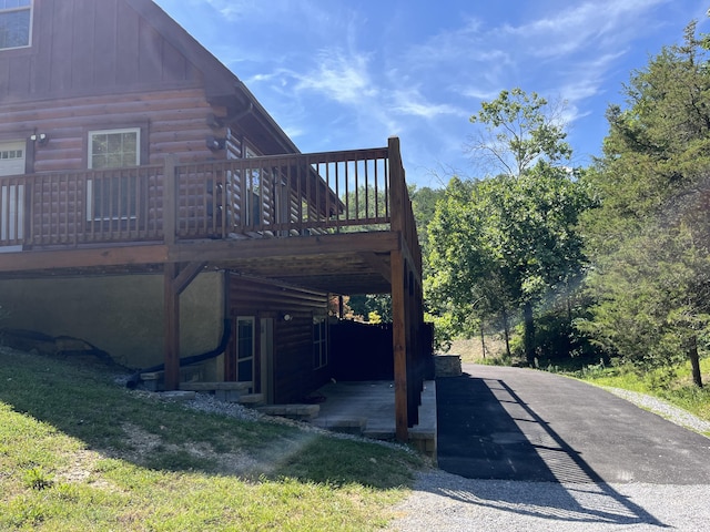 view of side of property featuring a wooden deck