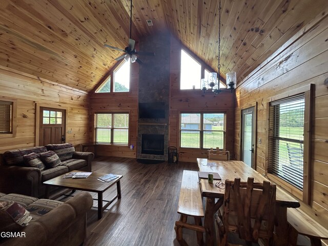 living room with dark hardwood / wood-style floors, high vaulted ceiling, and wooden ceiling