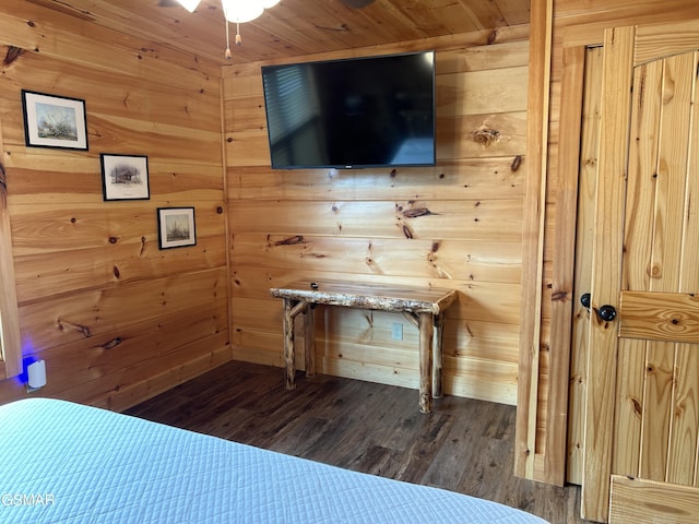 unfurnished bedroom featuring dark hardwood / wood-style floors and wood walls