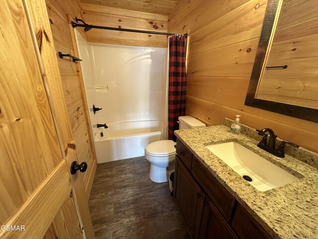 full bathroom with vanity, toilet, shower / bathtub combination with curtain, and wooden walls