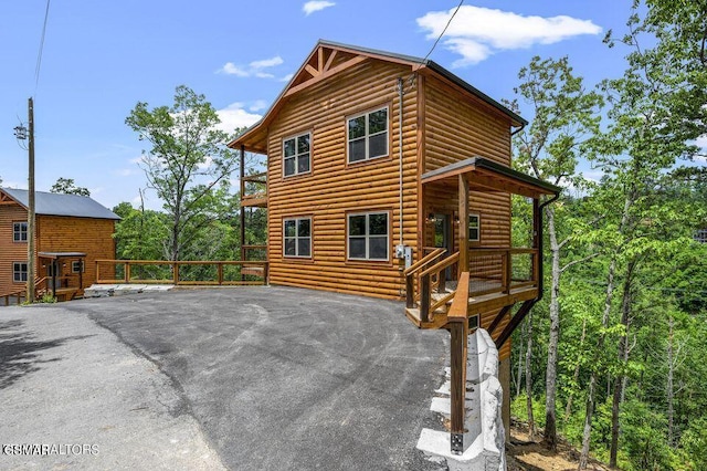 exterior space with log veneer siding