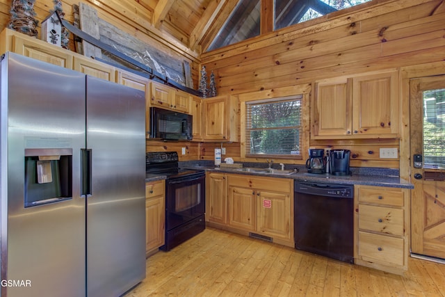 kitchen featuring light wood-type flooring, black appliances, sink, wooden ceiling, and beamed ceiling