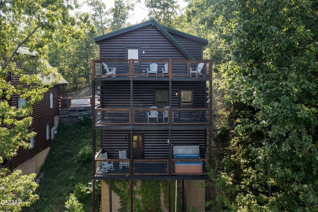 back of property featuring a balcony