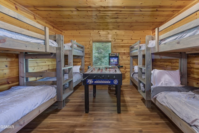 bedroom featuring wooden ceiling, dark wood-type flooring, and wooden walls