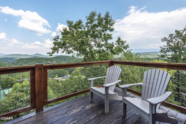 wooden deck featuring a mountain view