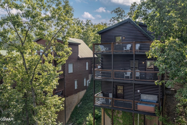 back of house featuring a balcony