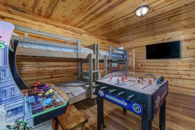 bedroom featuring dark hardwood / wood-style floors, wood walls, and wooden ceiling