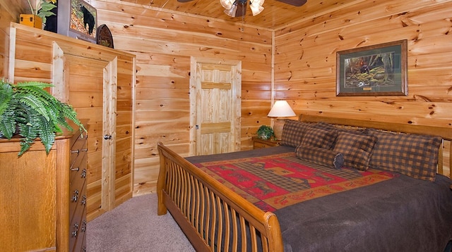 bedroom with carpet flooring and wood walls