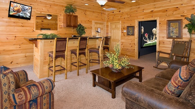 living room with ceiling fan, wood ceiling, and light carpet