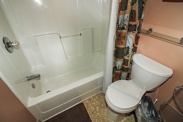 bathroom with shower / bath combination with curtain and toilet