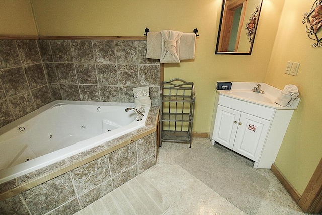 bathroom with tile patterned floors, vanity, and tiled bath