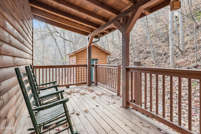 wooden deck featuring a storage shed