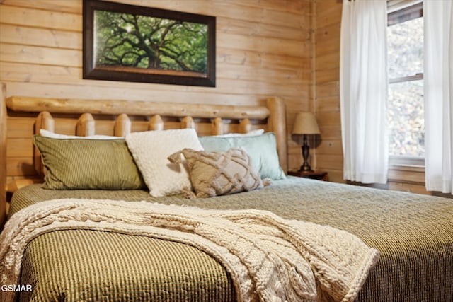 bedroom with wood walls