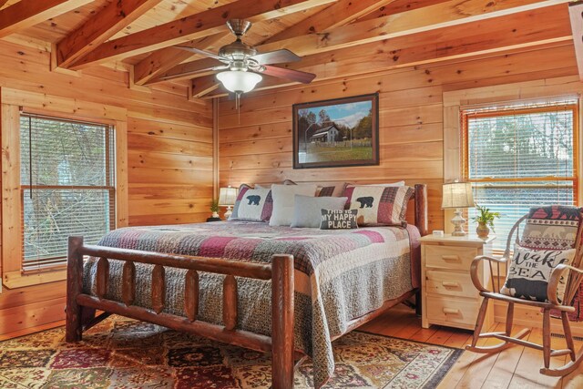 1706 Springer Rd, Sevierville, TN 37862 - bedroom with vaulted ceiling with beams, wood walls, and hardwood / wood-style flooring