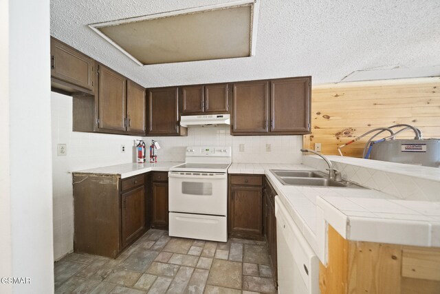260 Roaring Fork Rd Unit 217, Gatlinburg, TN 37738 - kitchen featuring under cabinet range hood, a sink, tile counters, stone finish floor, and white electric range oven