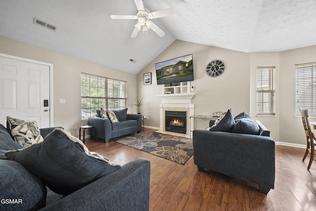 1733 Snapp Rd, Sevierville, TN 37862 - living area with wood finished floors, a textured ceiling, a ceiling fan, a fireplace, and vaulted ceiling