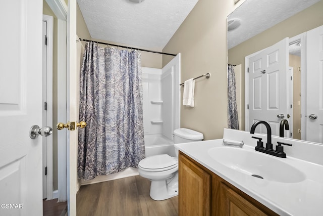 1733 Snapp Rd, Sevierville, TN 37862 - full bathroom with wood finished floors, vanity, a textured ceiling, toilet, and shower / tub combo with curtain