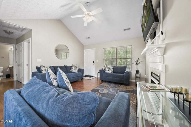 1733 Snapp Rd, Sevierville, TN 37862 - living area with wood finished floors, ceiling fan, a fireplace, baseboards, and a textured ceiling