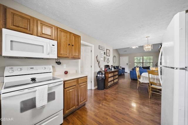 1733 Snapp Rd, Sevierville, TN 37862 - kitchen with white appliances, dark wood-style flooring, brown cabinets, light countertops, and a textured ceiling